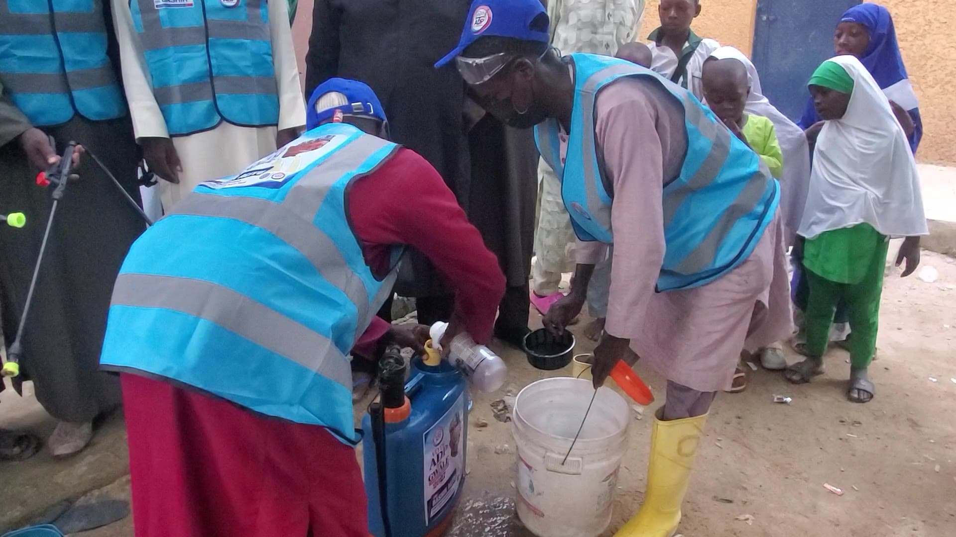 Programme personnel preparing sprayers and equipment in Dorayi.